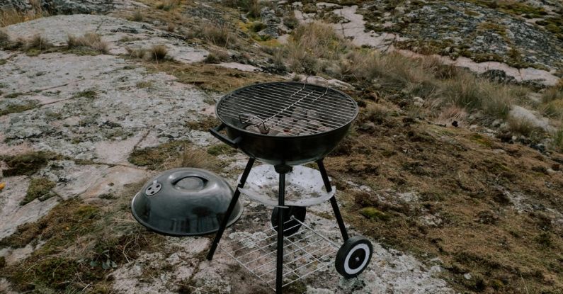 Outdoor Cooking - Eggs, Bacon and Bread Lying next to a Grill on the Shore