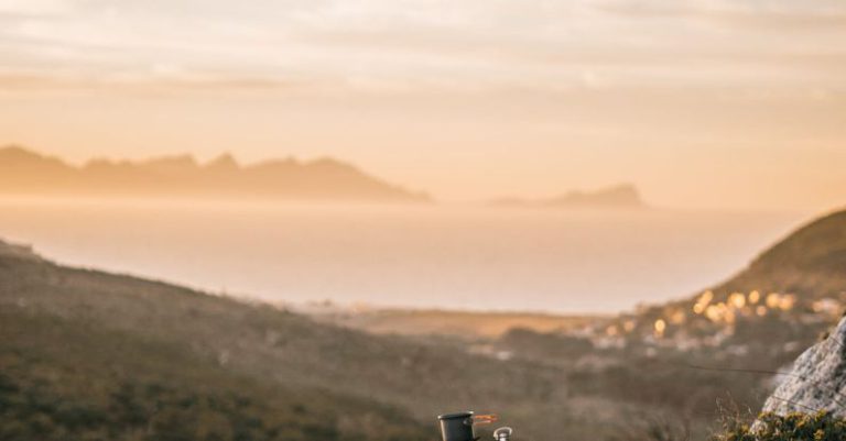 Outdoor Cooking - Outdoor Cooking Material on a Cliff of a Mountain Under Golden Sky