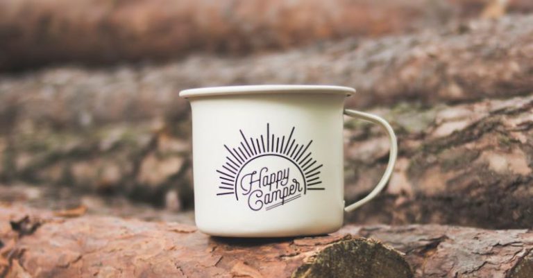 Camping - White Happy Camper-printed Cup on Brown Wooden Log