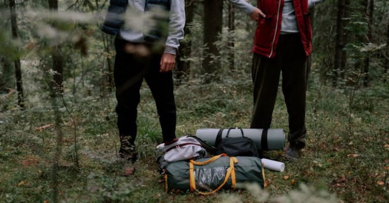 Camping Gear - People Standing at the Forest