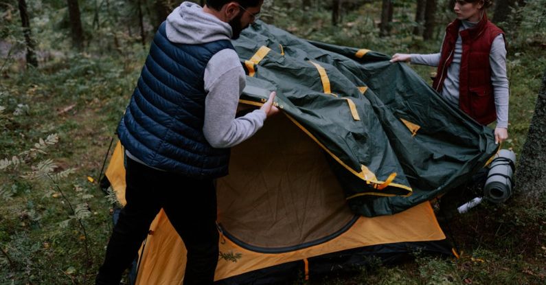 Camping Gear - Man and Woman Setting Up a Tent