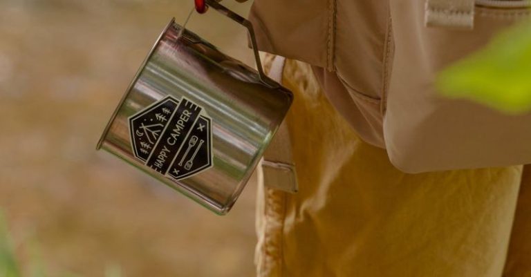 Camping Gear - A Stainless Steel Mug Hanging on a Hiker's Carabiner