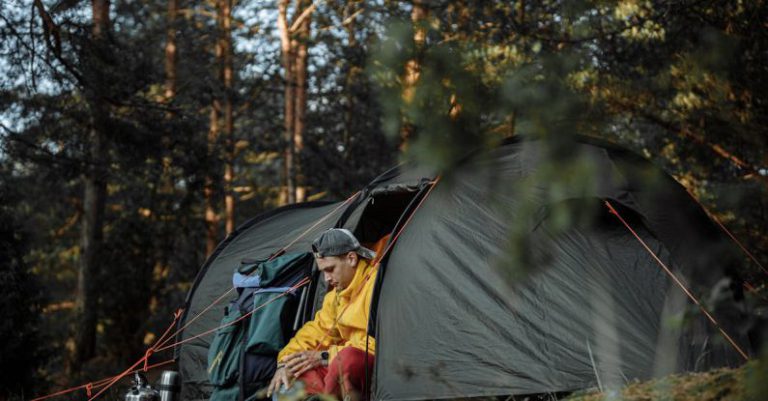 Camping Gear - Man Sitting inside a Tent