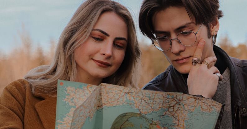 Hike Map - A man and woman looking at a map together