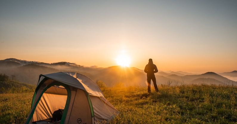 Hiking - Silhouette of Person Standing Near Camping Tent