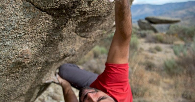 Climbing - Man Climbing on Gray Concrete Peak at Daytime