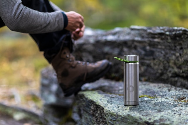 person-in-black-long-sleeve-shirt-holding-silver-tube